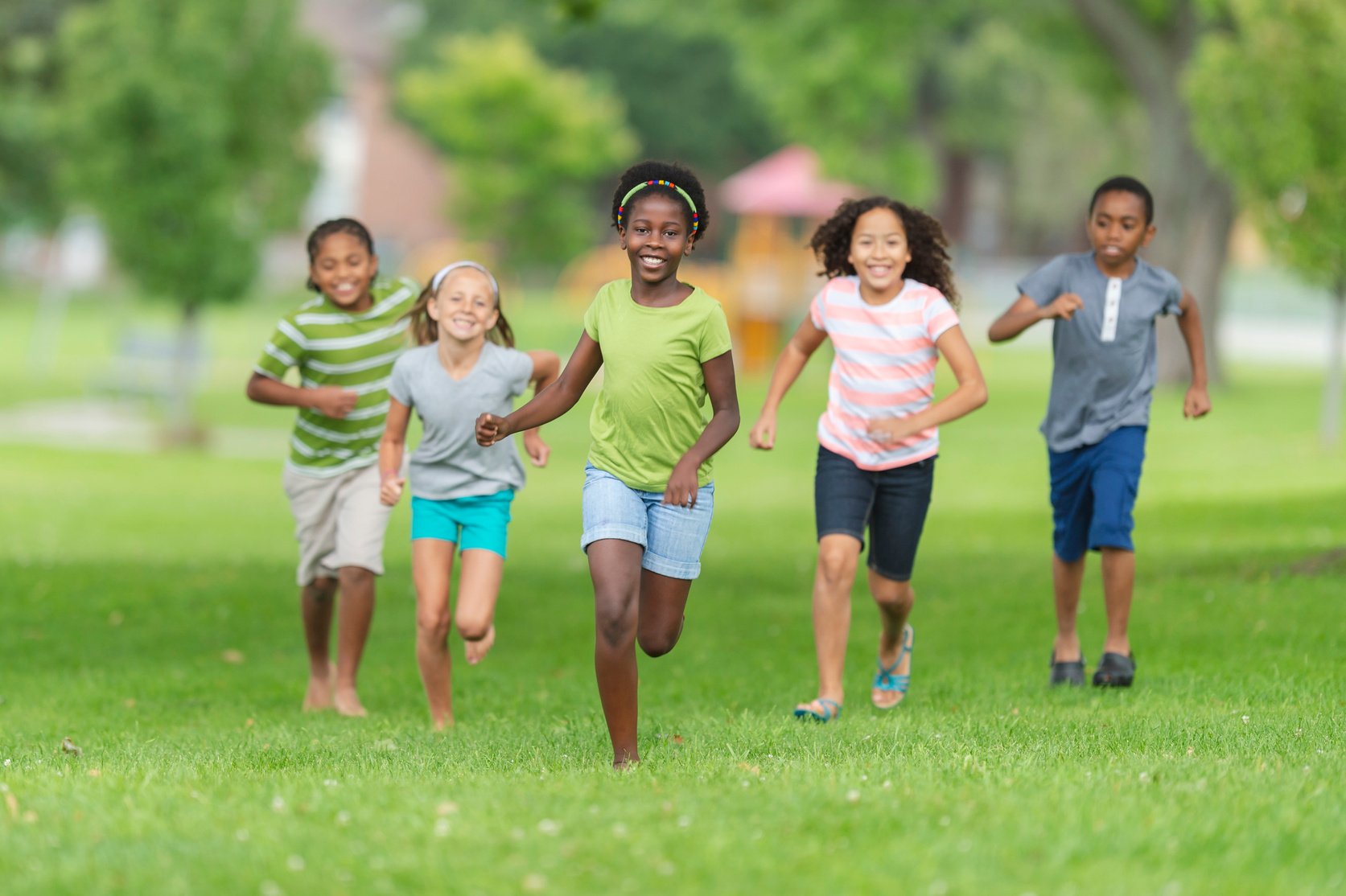 Children running through a park